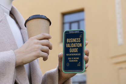 Person holding a phone with a business validation guide app and a coffee cup outdoors.